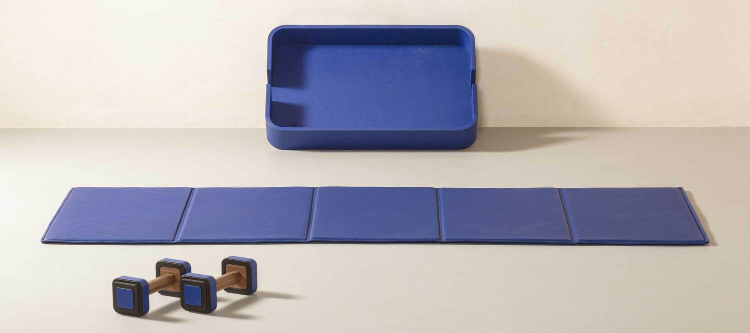 Fitness Collection exercise mat by Poltrona Frau with technical foam padding, Pelle Frau® leather cover, wooden tray, and artisanal Made in Italy details.
