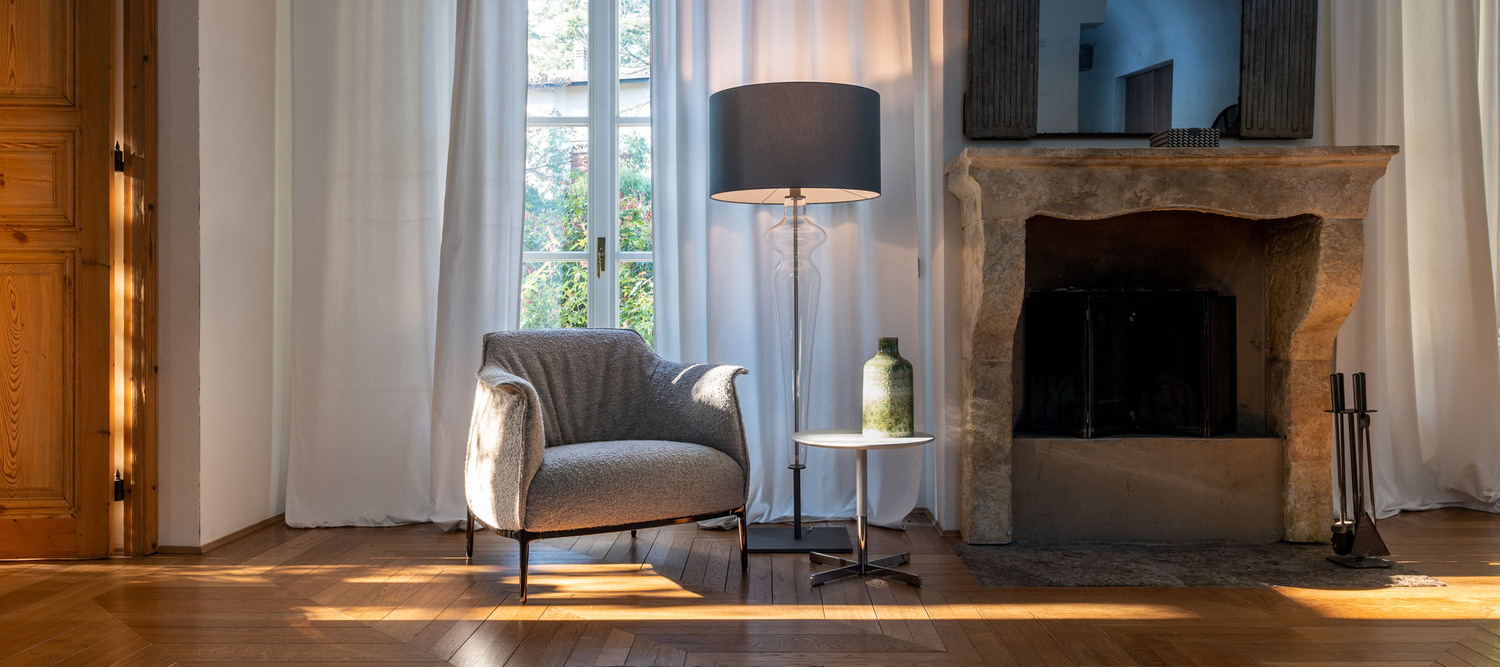 Holly lamp by Poltrona Frau, with a transparent glass silhouette evoking a stylized female profile, painted metal base and bronzed brass accents, elegant Italian artisan design